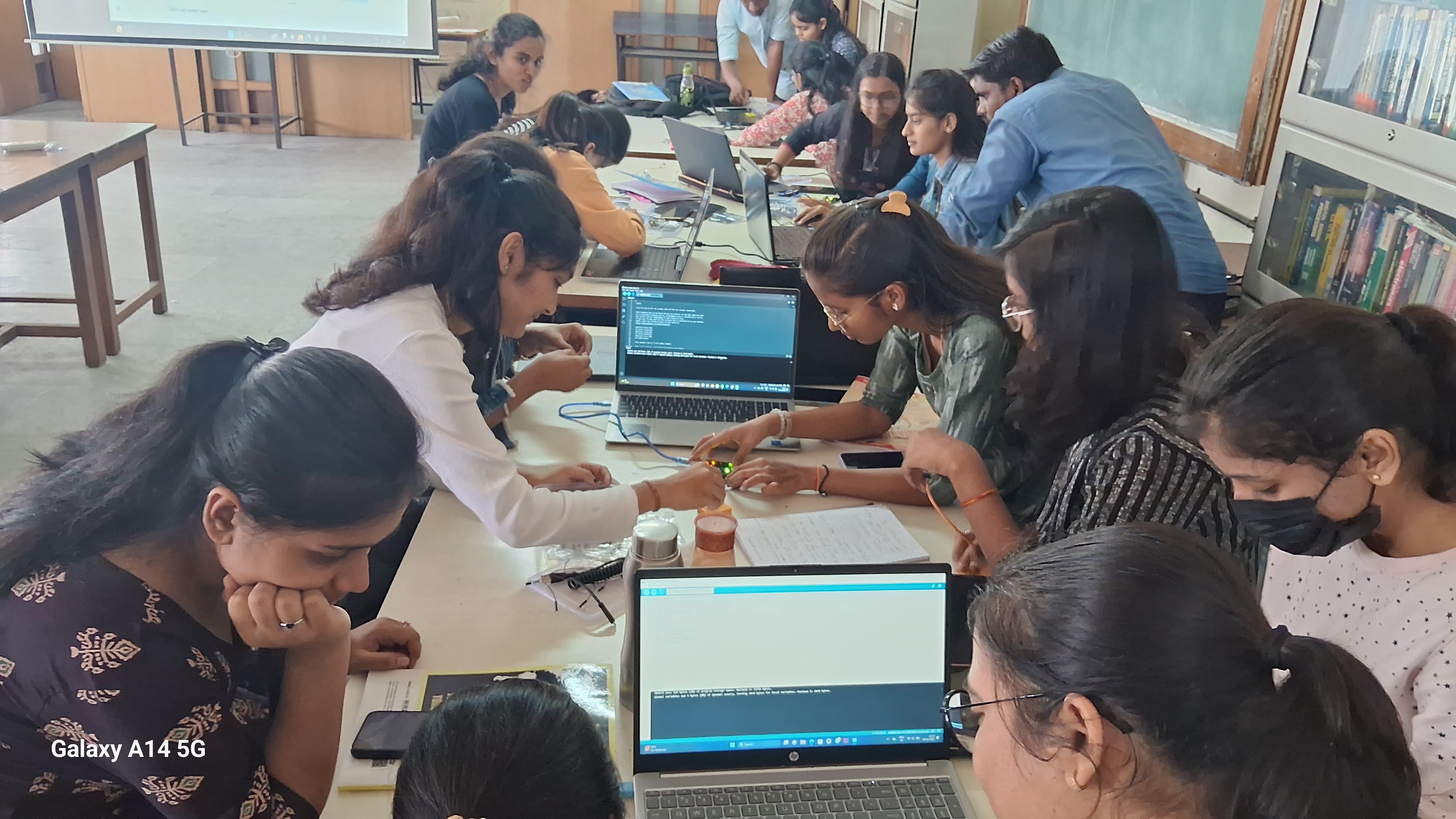 Engineering students building an Arduino IoT circuit during a hands-on workshop at Sinhgad College of Engineering Pune